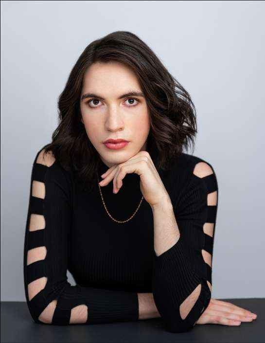 Aiden Cumming-Teicher (She/They) as Dr Whitley & Grocer